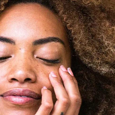 Woman touching her hand to her face