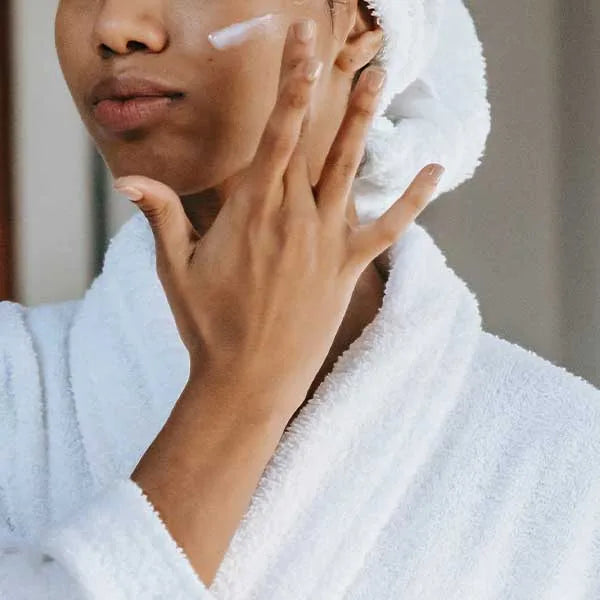 Woman applying skin product to face