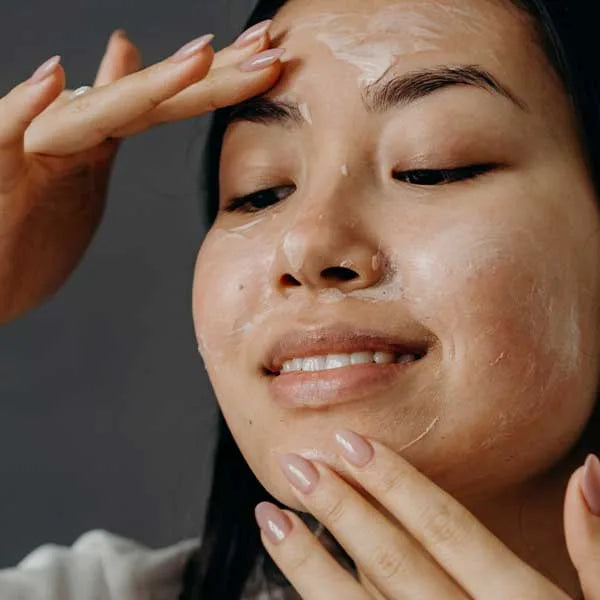 Woman cleansing her face