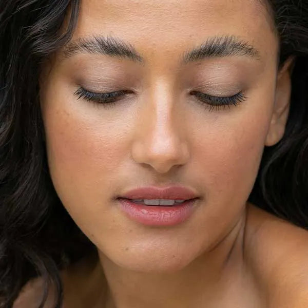 Woman's face looking down with natural makeup