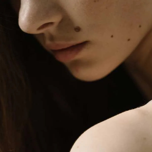 Close up shot of a woman's lower face and shoulder