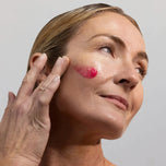 Skincare model applying HyalaVive to cheek
